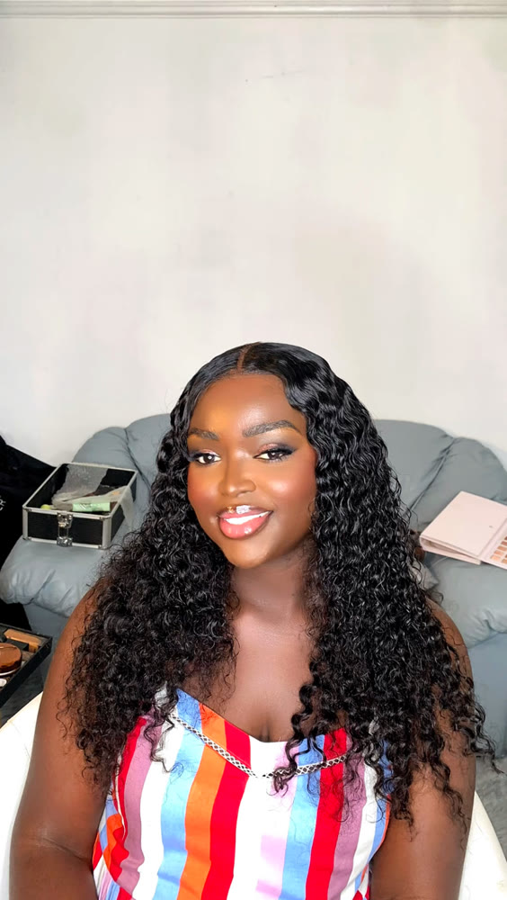 Voluminous curled hairstyle styled to complement a full glam look
